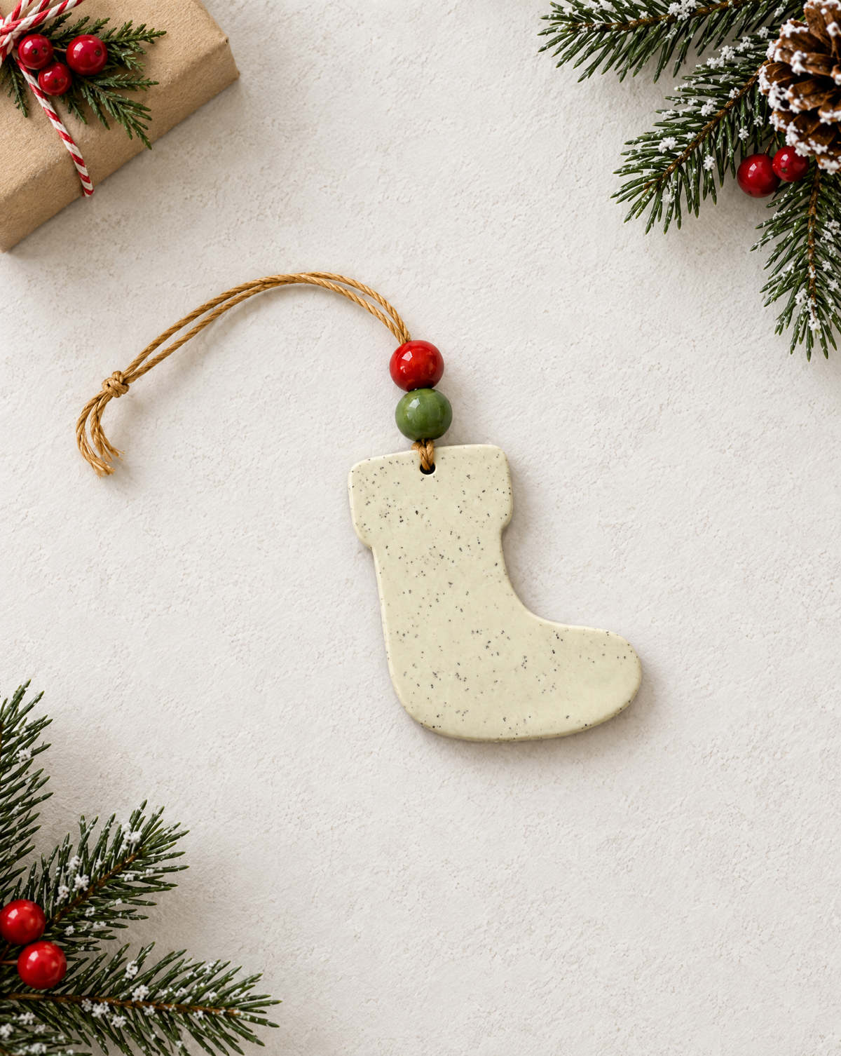 Handmade clay Christmas stocking ornament in speckled cream with twine cord hanger