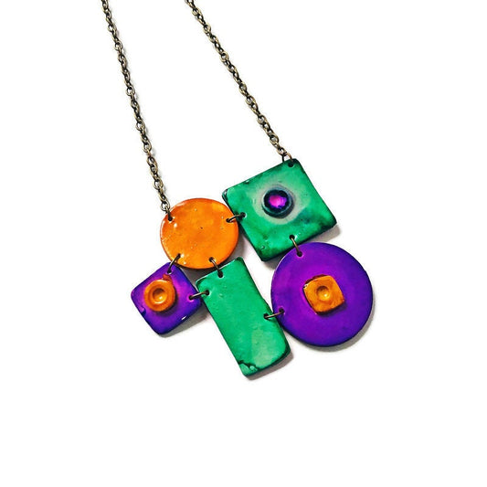 Colorful necklace with geometric pendants on a white background