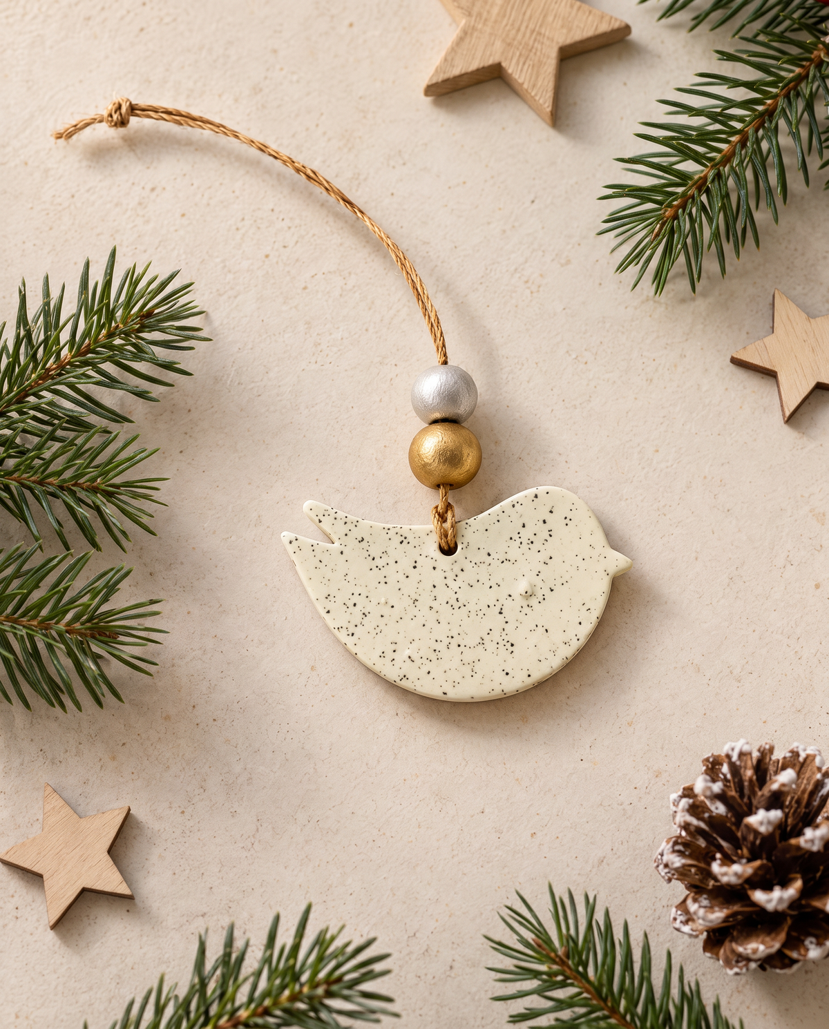 Speckled clay bird ornament on twine with silver and gold bead top loop