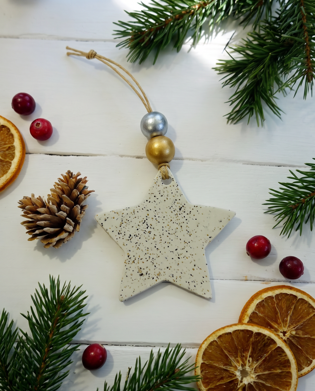 Handmade star Christmas ornament, light speckled clay star with gold bead hanger.
