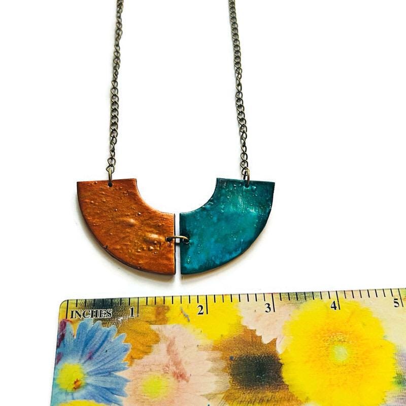 Necklace with bronze and teal half-circle pendants