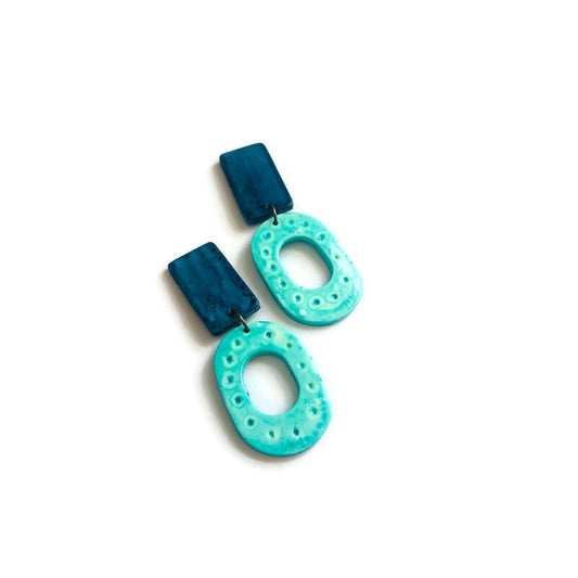 Pair of blue and turquoise earrings on a white background