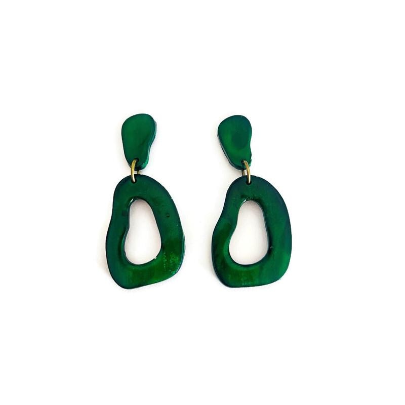 Pair of dark green polymer clay teardrop drop earrings with gold posts and oval cutouts