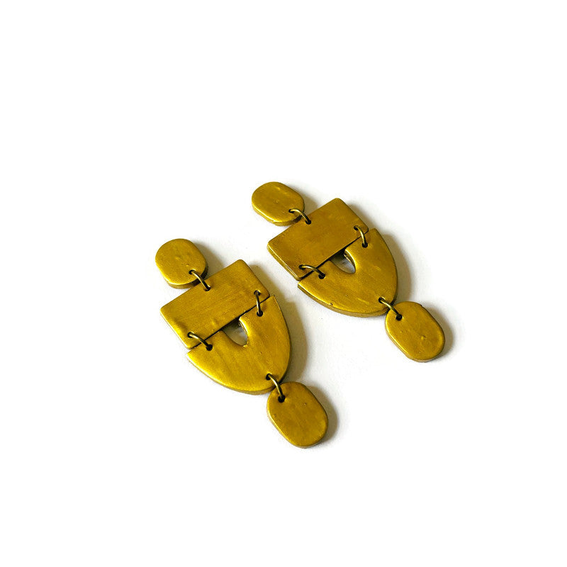 Gold statement drop earrings with layered geometric panels and teardrop charm drops.