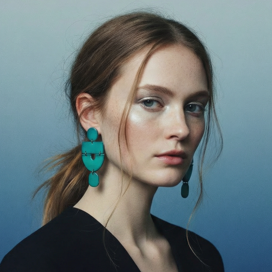 Woman wearing turquoise earrings against a blue gradient background