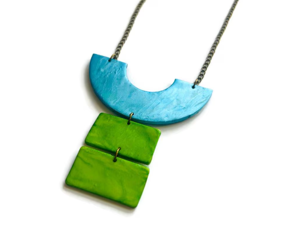 Necklace with blue and green geometric pendant on a white background