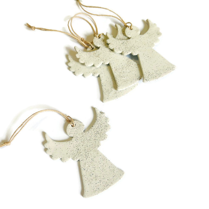 angel-shaped decorations on strings against a white background