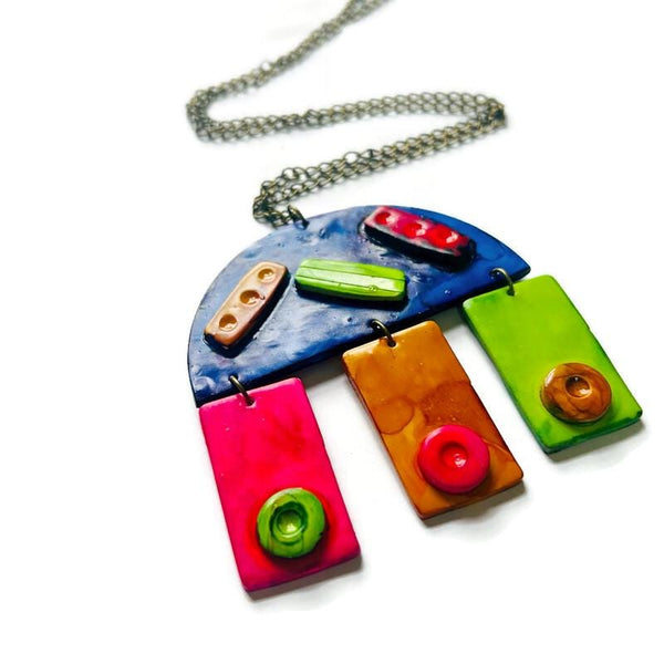 Colorful necklace with geometric pendants on a white background