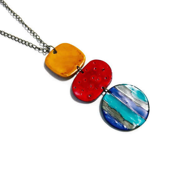 Necklace with three colorful oval pendants on a white background