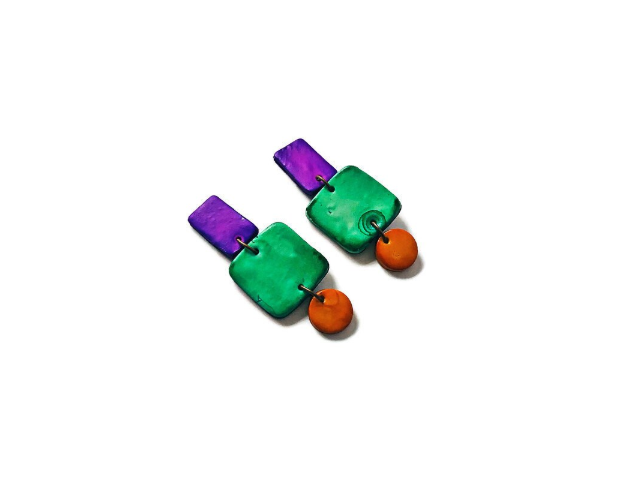 Pair of colorful earrings with green, purple, and orange components on a white background