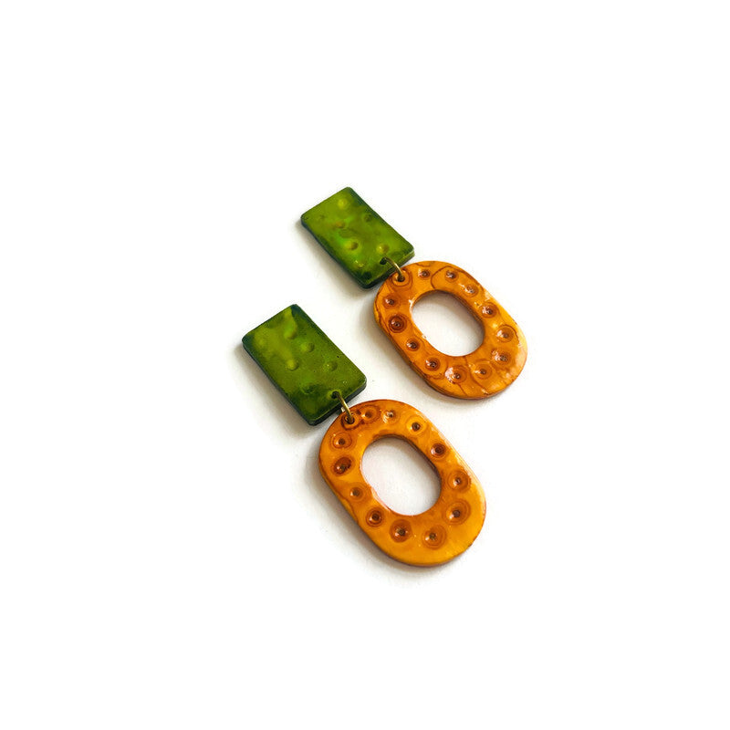 Pair of green and yellow earrings on a white background