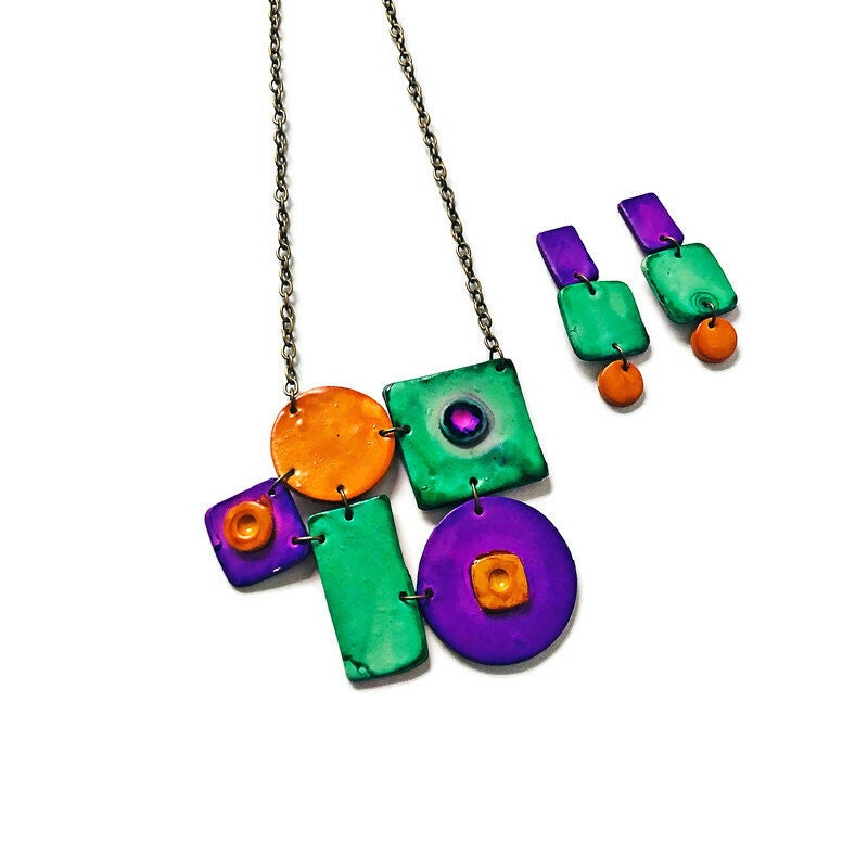Colorful necklace with square and round pendants on a white background