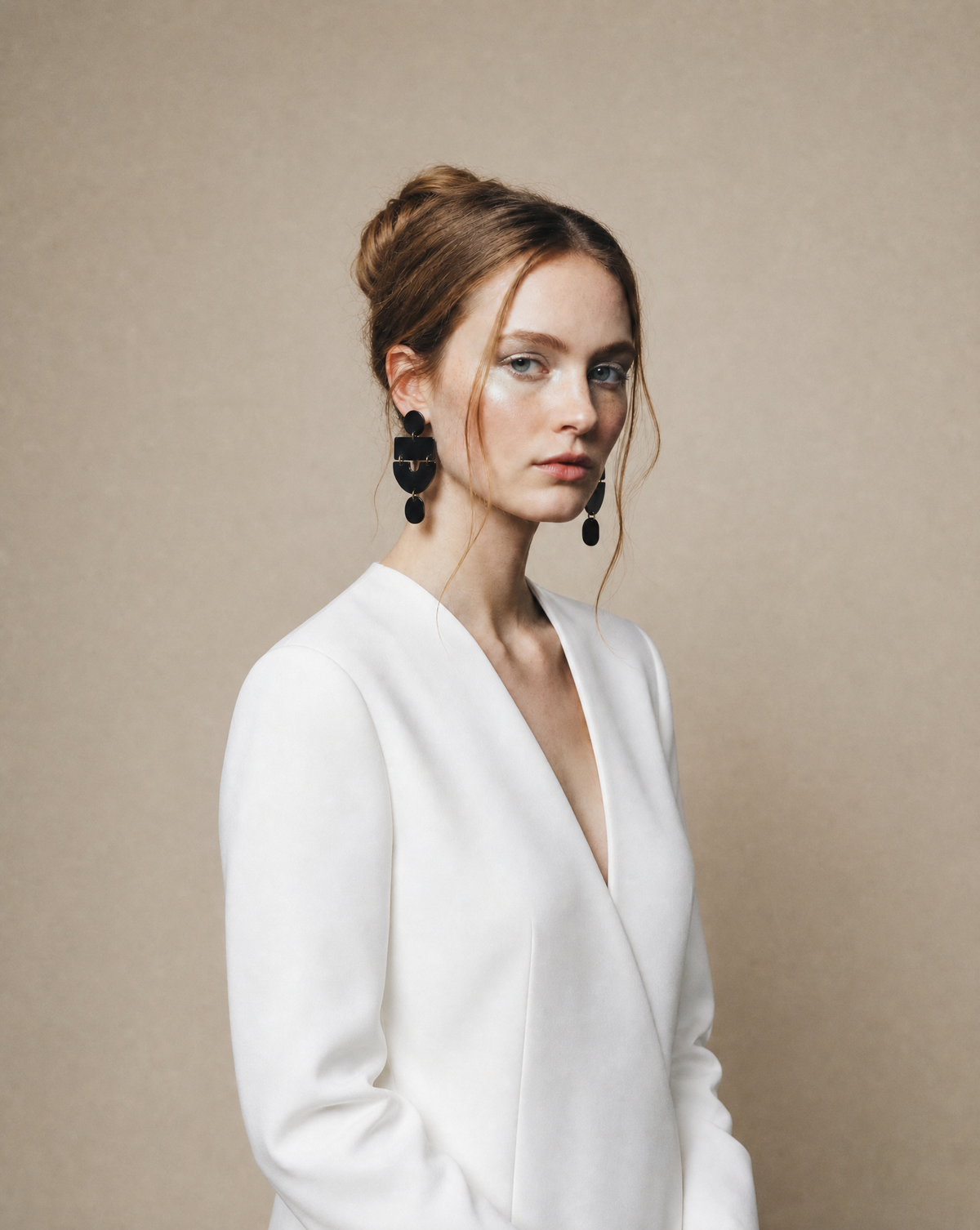 Long statement drop earrings on model: dark geometric squares with teardrop dangles.