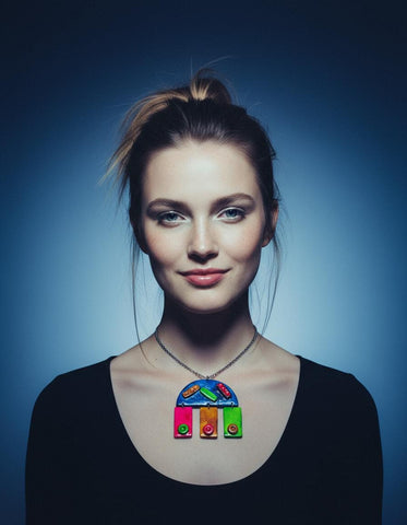 Woman wearing a colorful necklace against a blue background