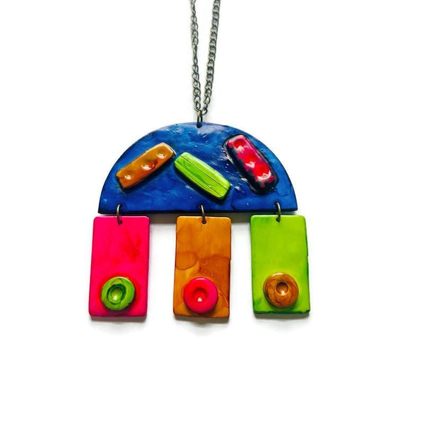 Colorful pendant necklace with a blue arch and rectangular colorful pendants on a white background