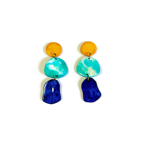 Colorful earrings with blue, green, and orange components on a white background