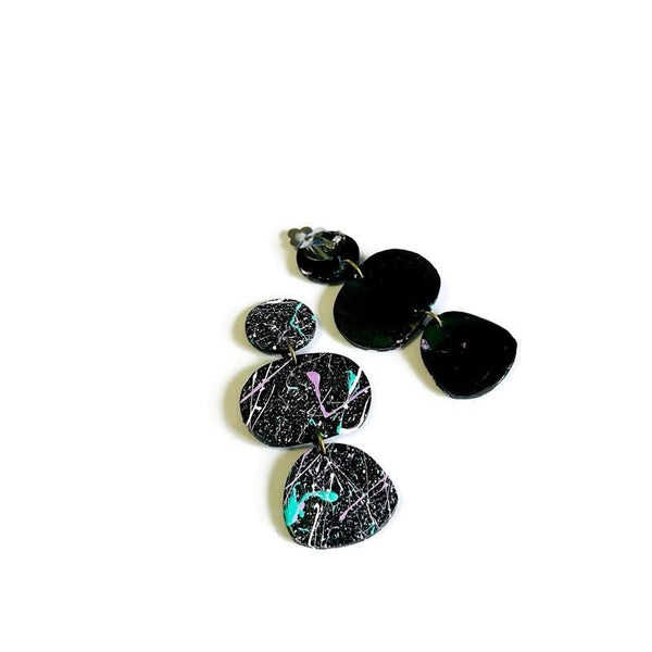 Black and multicolored earrings on a white background