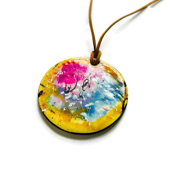 Colorful round pendant necklace on a white background