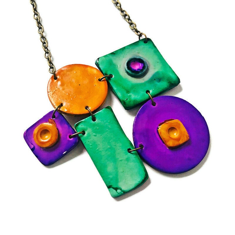 Colorful necklace with square and round pendants on a white background