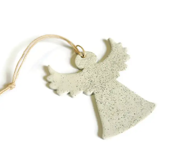 Close-up of speckled white clay angel Christmas ornament with hanging loop