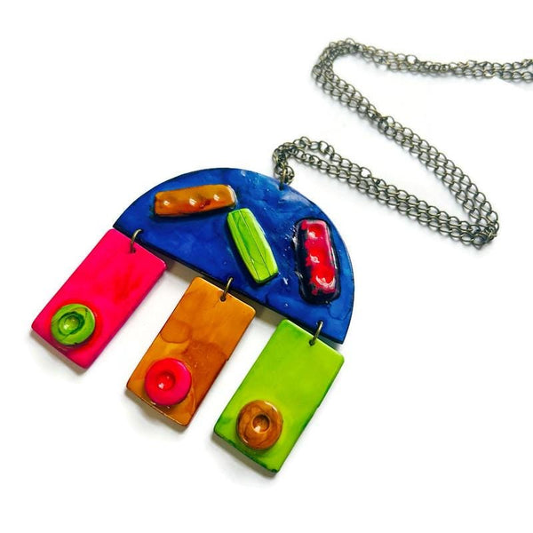 Colorful pendant necklace with a chain on a white background