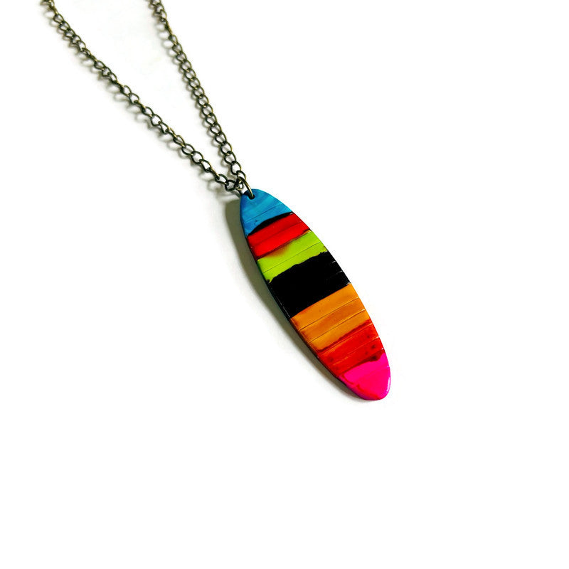 Necklace with a colorful striped pendant on a white background