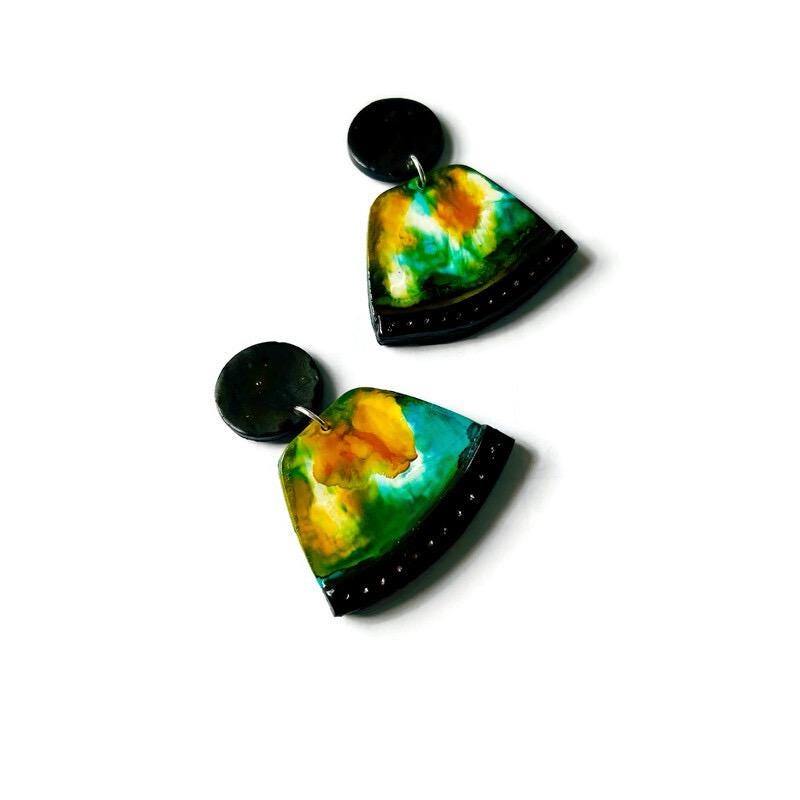 Pair of colorful fan-shaped earrings on a white background