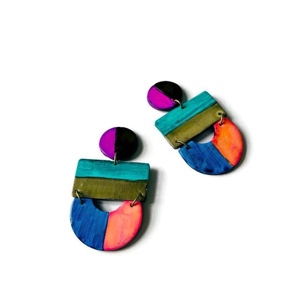 Colorful earrings with geometric design on a white background