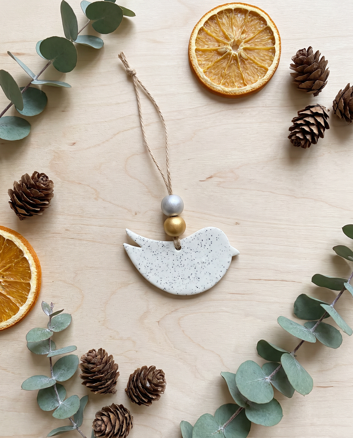 Handmade speckled clay bird ornament with twine loop and silver, gold beads