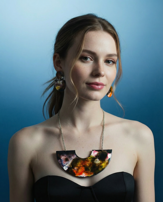 Woman wearing a colorful necklace against a blue background