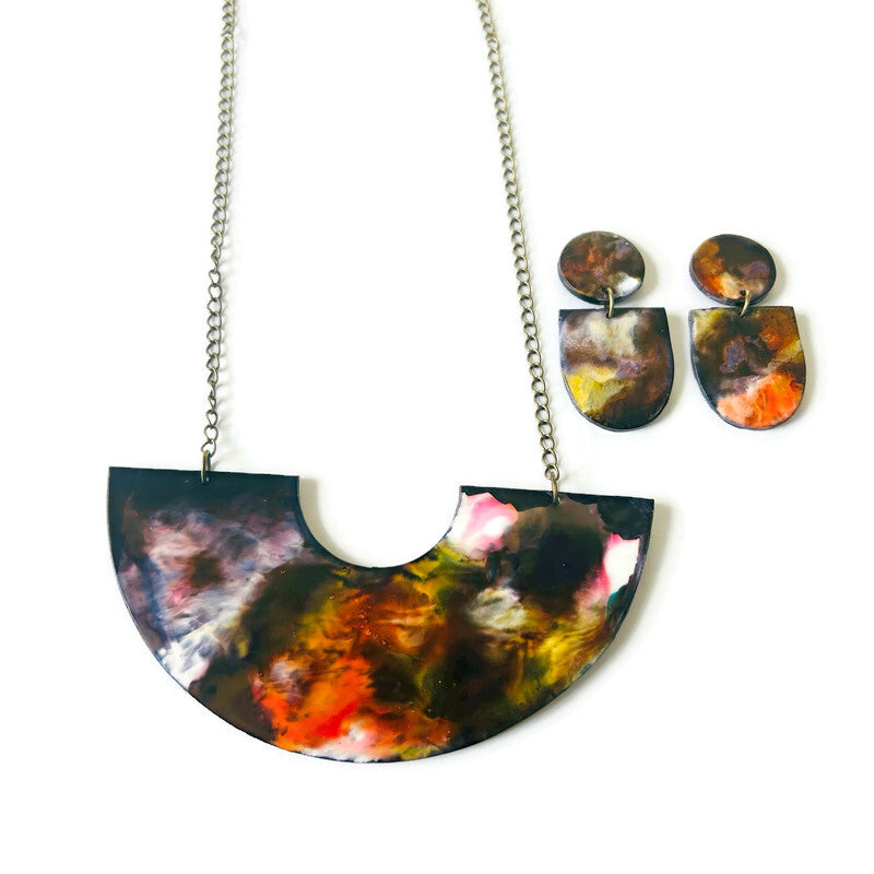 Colorful necklace and earrings set on a white background