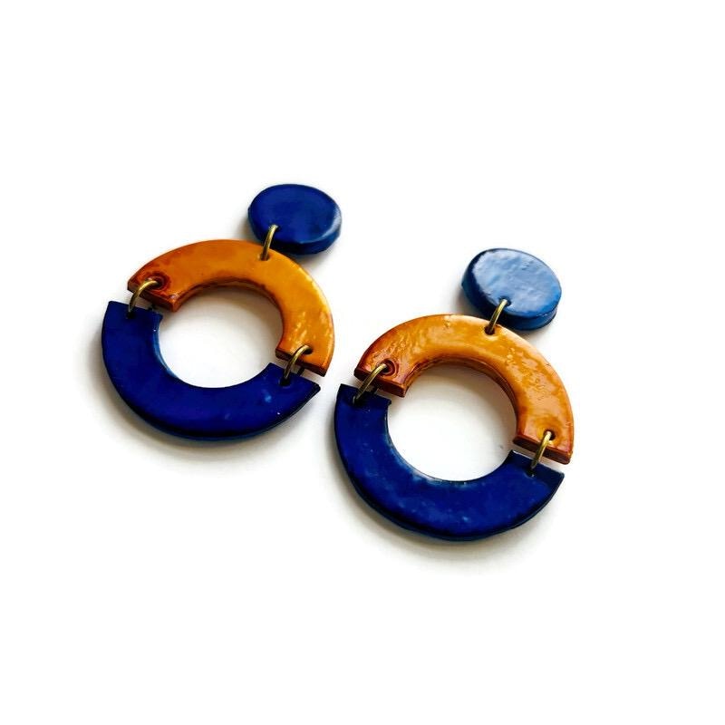 Pair of blue and yellow hoop earrings on a white background