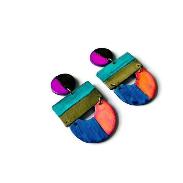 Colorful earrings with geometric design on a white background