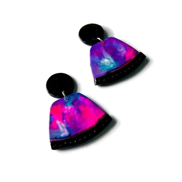 Colorful abstract earrings with black accents on a white background