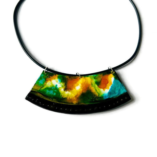 Necklace with a colorful, semi-circular pendant on a white background