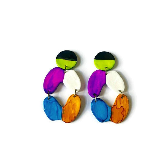 Colorful earrings with multiple oval shapes on a white background