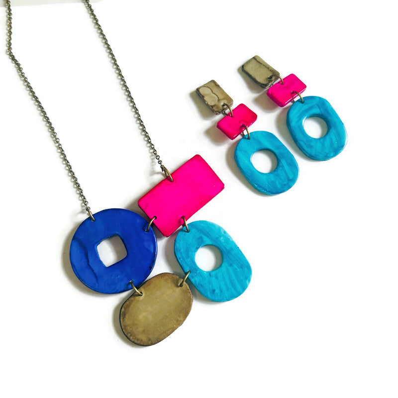 Necklace and earrings with colorful geometric shapes on a white background