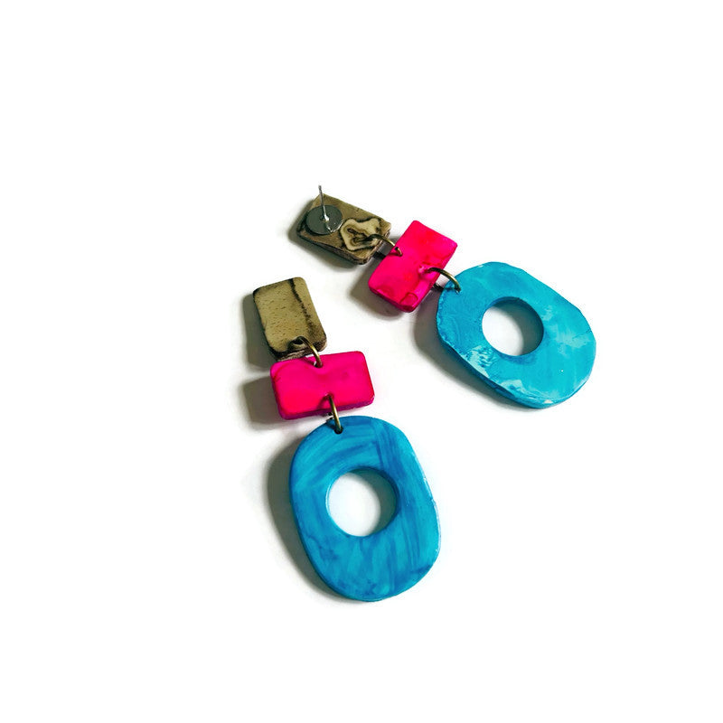 Colorful earrings with blue and pink components on a white background