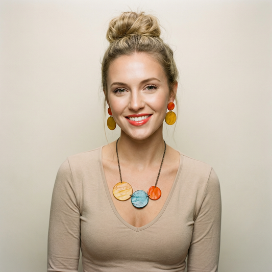 Woman wearing colorful necklace and earrings against a plain background