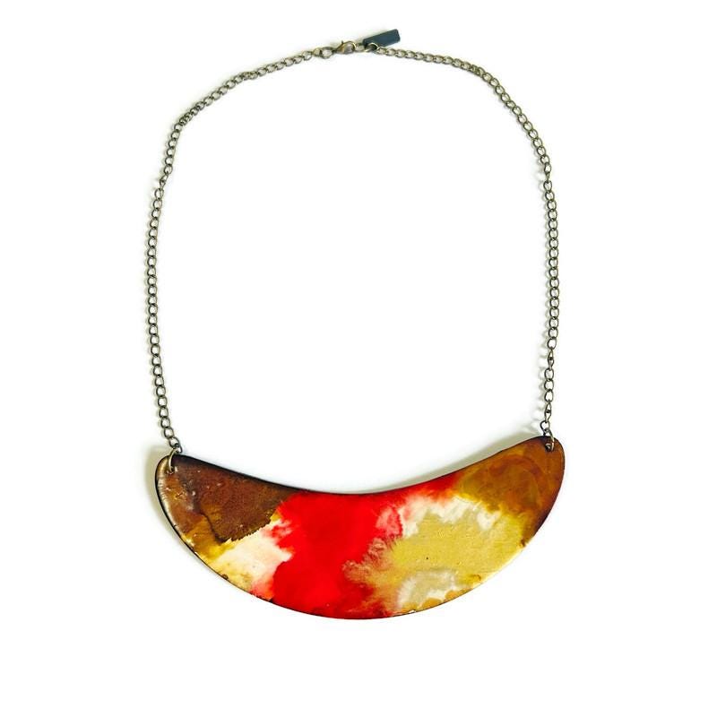 Colorful necklace with a half-circle pendant on a white background