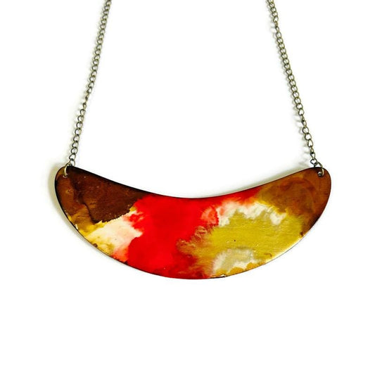 Colorful half-circle pendant necklace on a white background