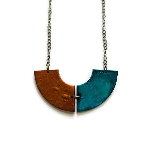 Necklace with a split pendant in brown and blue on a white background