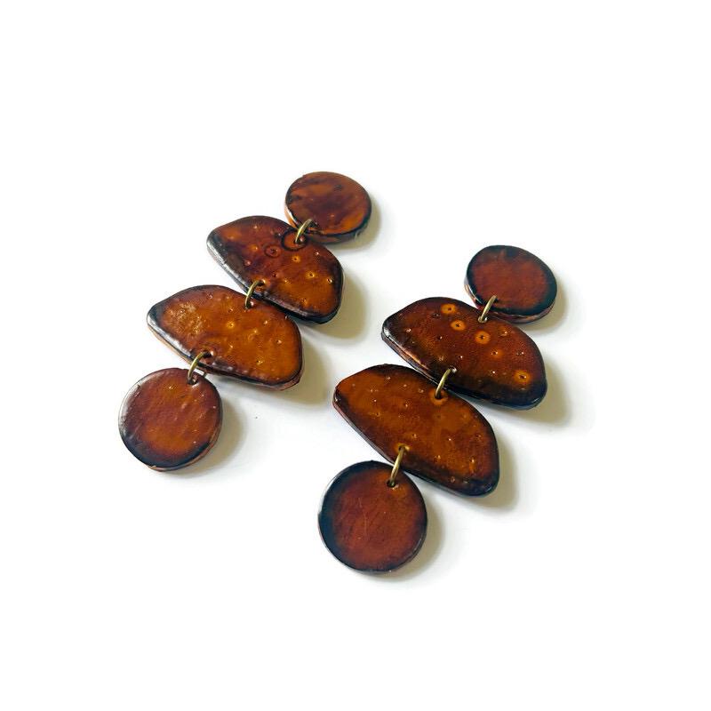 Pair of brown earrings on a white background