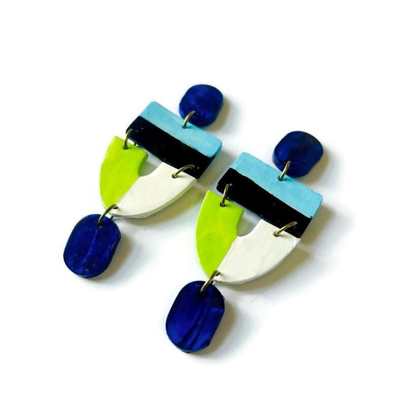 Colorful earrings with geometric design on a white background
