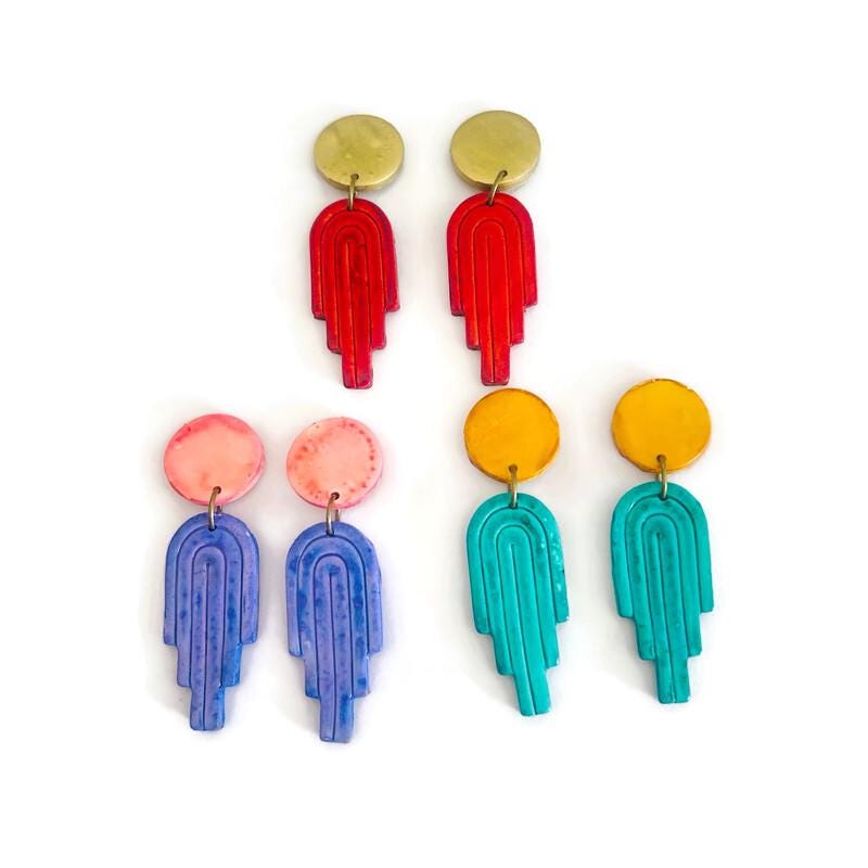 Assorted polymer clay dangle earrings in pink, purple, red, teal, and blue