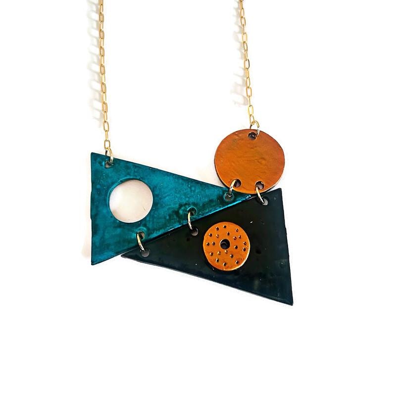 Geometric triangle statement necklace: teal and dark pendant with orange charm, gold chain