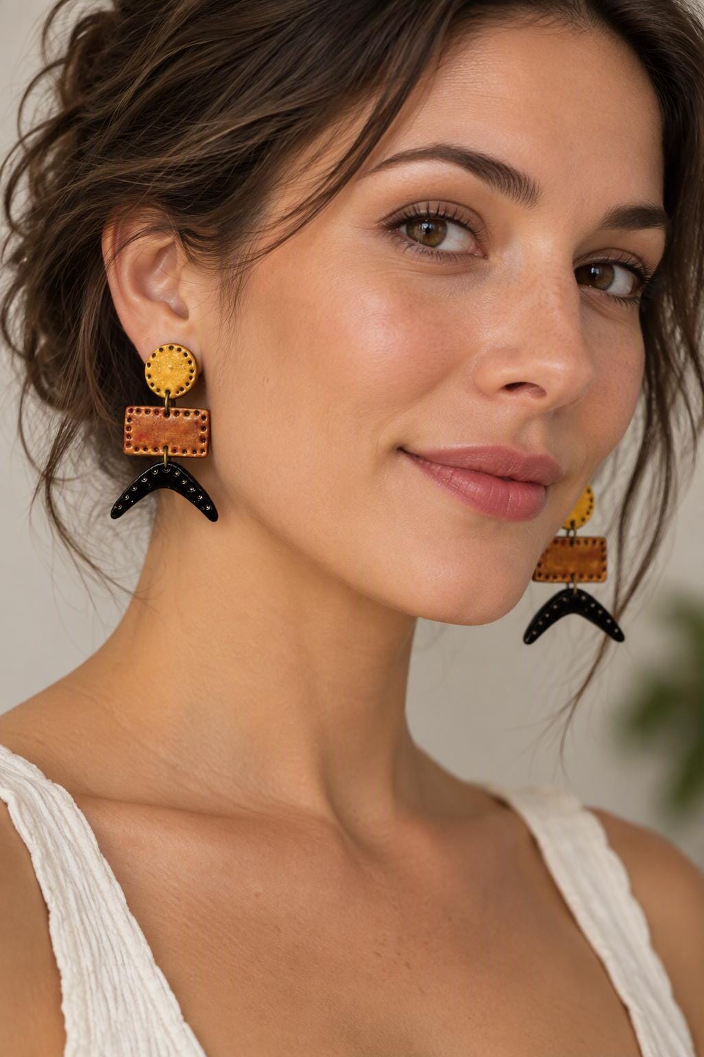 Geometric drop dangle earrings with round yellow tops, copper bars, and black spikes.
