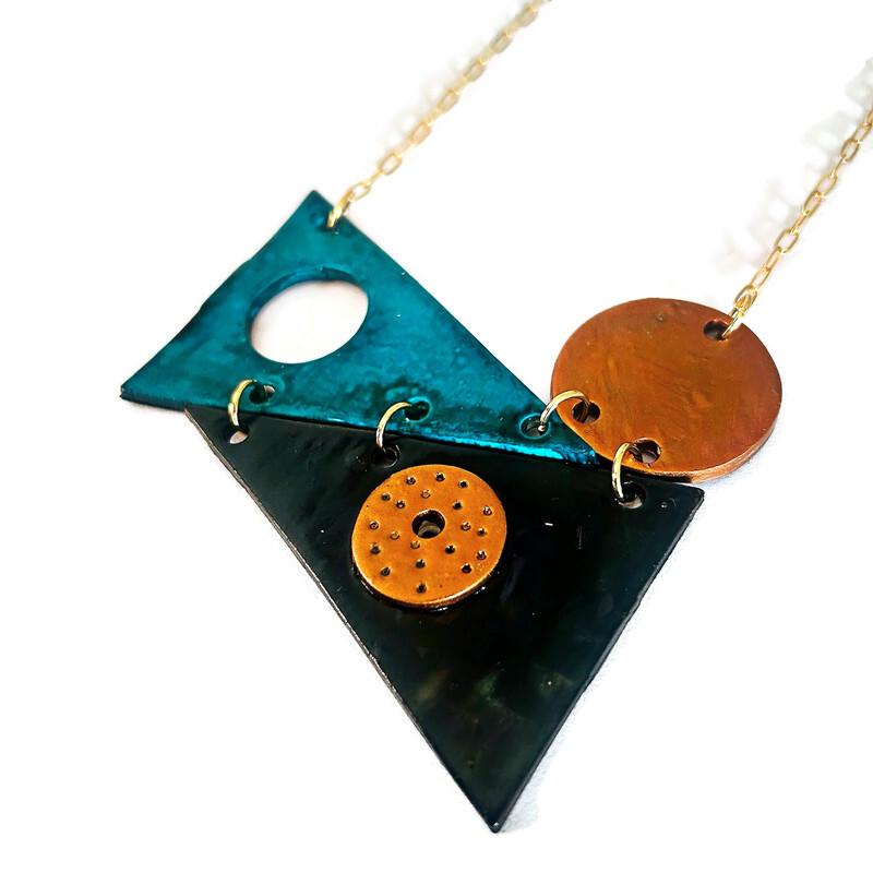 Layered triangle pendant necklace in teal and dark with orange round disc, gold chain