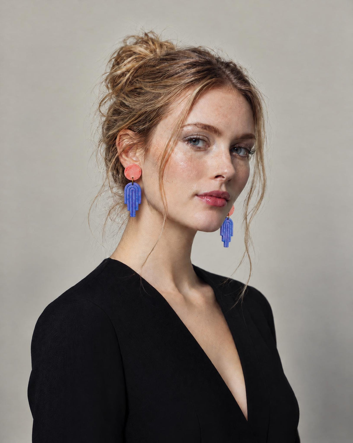 Long polymer clay dangle earrings with pink round tops and blue geometric drops