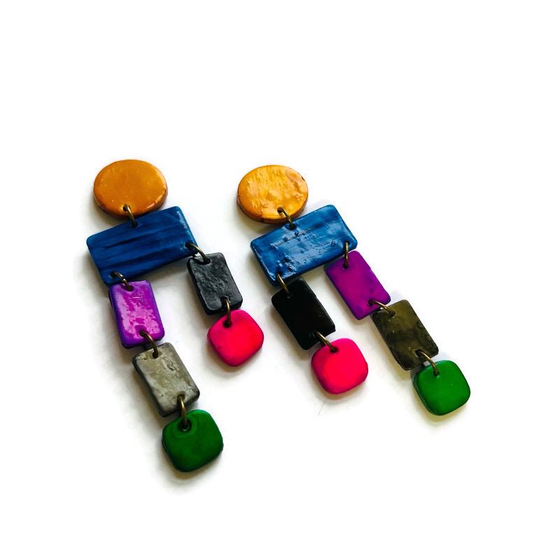 Colorful earrings with various shapes and colors on a white background